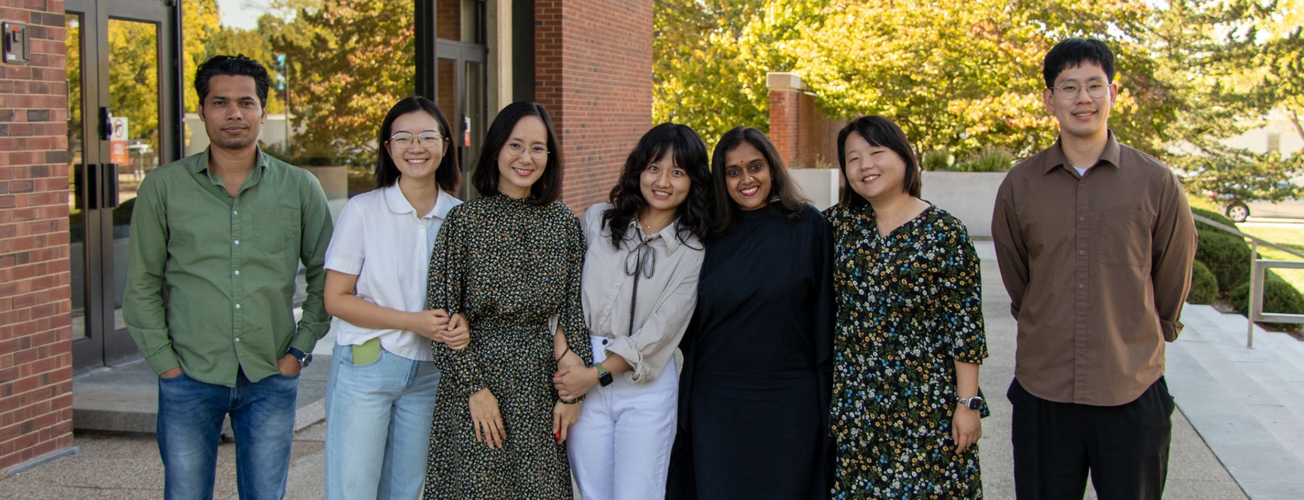 Graduate students pose on the steps of the college of education