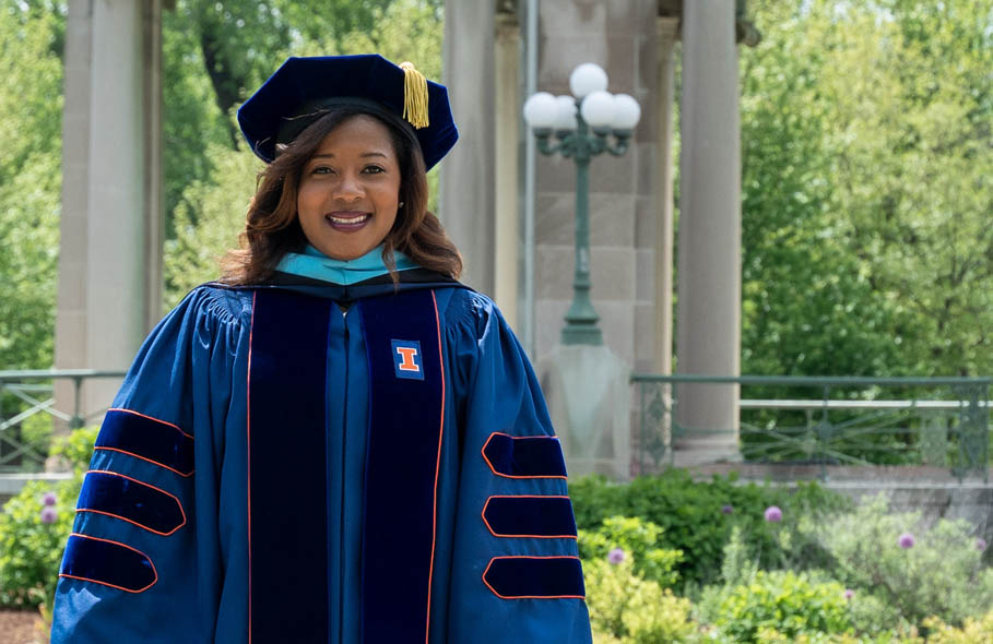 Danielle Huff smiling in regalia outside